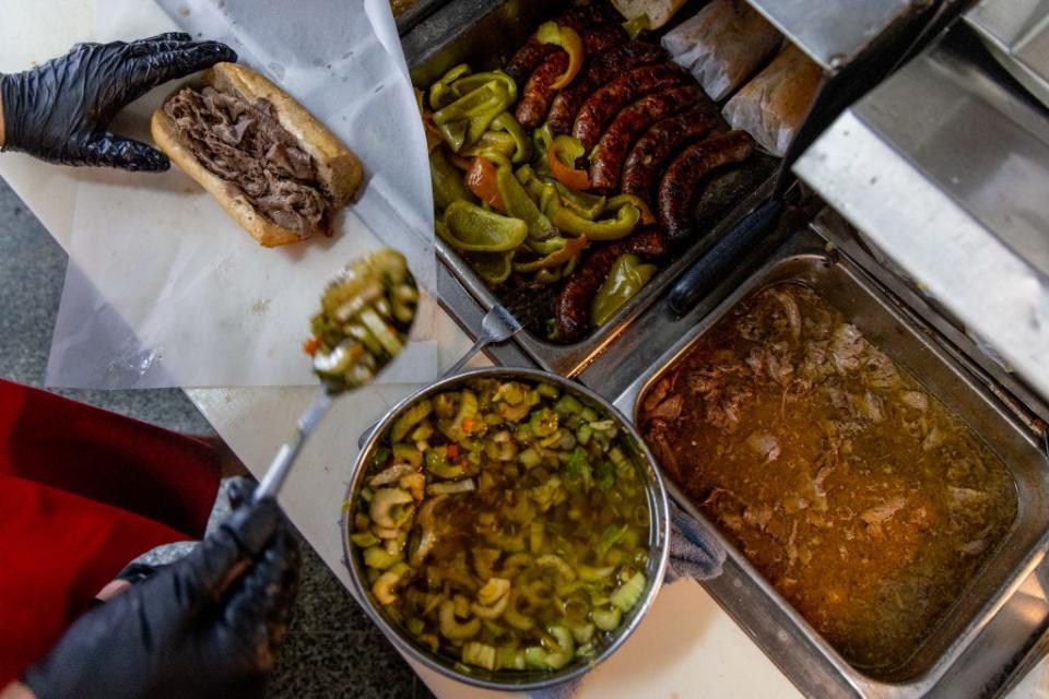 Giardiniera is scooped onto an Italian Beef Sandwich at Mr. Beef