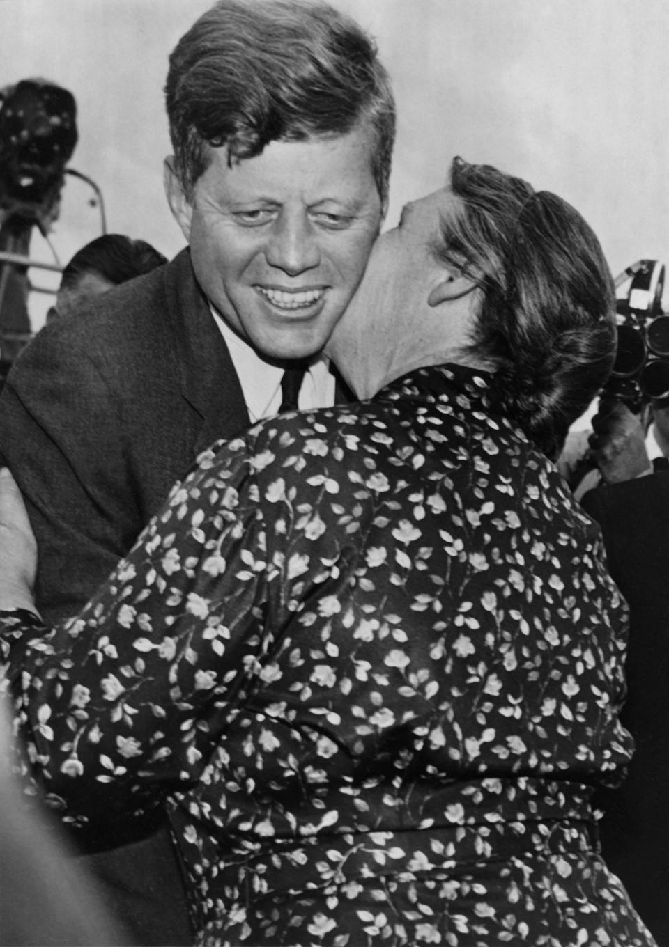 President John Fitzgerald Kennedy is kissed by his Irish cousin Mary Ryan during his visit in Dunganstown, County Wexford, on June 28, 1963.