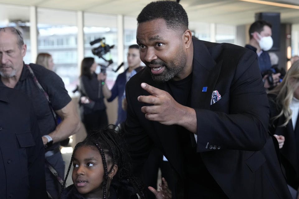 Newly-named New England Patriots head coach Jerod Mayo speaks with his daughter Chylo, 6, after facing reporters Wednesday, Jan. 17, 2024, during an NFL football news conference, in Foxborough, Mass. Mayo succeeds Bill Belichick as the franchise's 15th head coach. (AP Photo/Steven Senne)