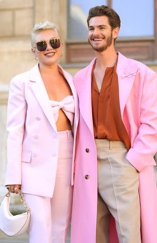 <p>Jacopo Raule/Getty Images</p> Florence Pugh and Andrew Garfield pose at the Valentino show