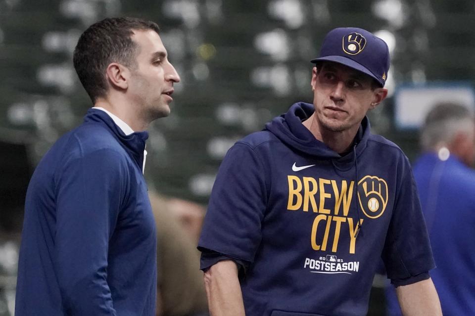 Milwaukee Brewers manager Craig Counsell talks to general manager David Stearns at a practice for the Game 1 of the NLDS baseball game Thursday, Oct. 7, 2021, in Milwaukee. The Brewers plays the Atlanta Braves in Game 1 on Friday, Oct. 8, 2021. (AP Photo/Morry Gash)