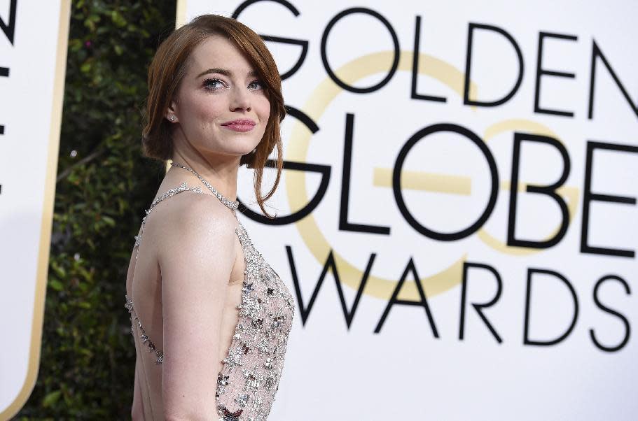 FILE- In this Jan. 8, 2017, file photo, Emma Stone arrives at the 74th annual Golden Globe Awards at the Beverly Hilton Hotel in Beverly Hills, Calif. Madonna, Stone, Willow Smith and first lady Michelle Obama are among 150 women chosen by editors of Harper's Bazaar as the world’s most fashionable, the list was released Tuesday, Jan. 10, 2017. (Photo by Jordan Strauss/Invision/AP, File)
