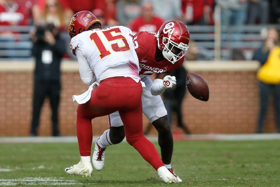 OU's Key Lawrence (12) forces a fumble as he hits Iowa State's Brock Purdy (15) during the Sooners' 28-21 win Saturday.