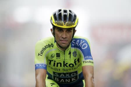 Tinkoff-Saxo team rider Alberto Contador of Spain crosses of the 161-km (100 miles) eighth stage of the Tour de France cycling race between Tomblaine and Gerardmer La Mauselaine, July 12, 2014. REUTERS/Jacky Naegelen