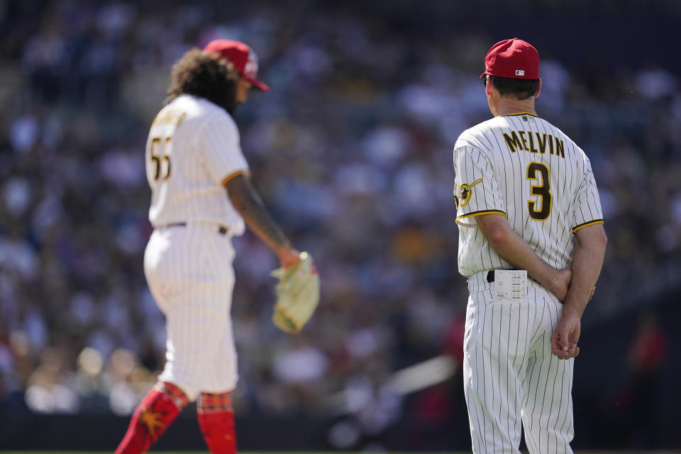 San Diego Padres manager Bob Melvin (3) watches starting pitcher Sean Manaea throw a few pitches after being hit on a comebacker from Seattle Mariners' Carlos Santana during the third inning from of a baseball game Monday, July 4, 2022, in San Diego. (AP Photo/Gregory Bull)