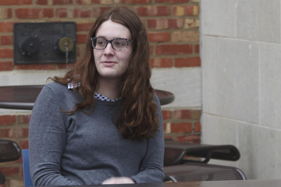 Transgender University of Kansas senior Jenna Bellemere speaks with fellow students outside the university's Memorial Union after an interview, Tuesday, March 26, 2024, in Lawrence, Kan. Bellemere says she's hoping that university administrators add pro-transgender rights language to policies to counter the negative messages from legislators rolling back transgender rights. (AP Photo/John Hanna)