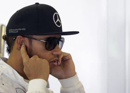 Mercedes Formula One driver Lewis Hamilton of Britain prepares for the first free practice session of the Hungarian Grand Prix at the Hungaroring circuit, near Budapest July 25, 2014. REUTERS/David W Cerny