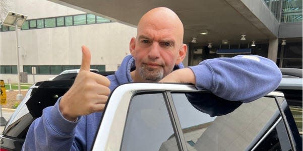 Fetterman giving thumbs up as he gets in car