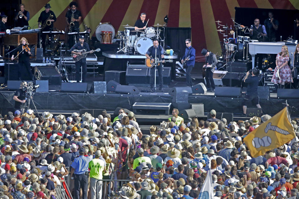 Bruce Springsteen, center, performs with the E Street Band at the New Orleans Jazz and Heritage Festival in New Orleans, Saturday, May 3, 2014. (AP Photo/Gerald Herbert)