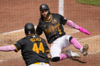 Pittsburgh Pirates' Connor Joe (2) scores from third on a sacrifice fly to right field by Jared Triolo off Cubs relief pitcher Colten Brewer during the sixth inning of a baseball game in Pittsburgh, Sunday, May 12, 2024. (AP Photo/Gene J. Puskar)