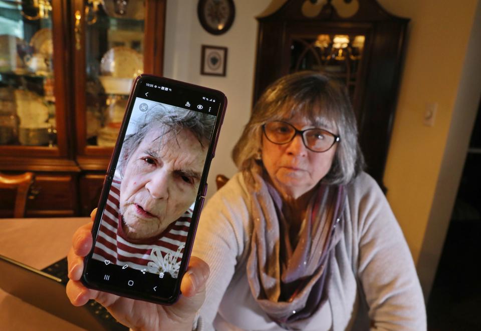 Jean Wells with a photo of her mother, Janet Deisenroth, at her home in Irondequoit Thursday, April 21, 2022.  The photo was taken by Wells of her mother while a resident at The Hurlbut Nursing Home, on Oct. 22, 2021.  Her mother would die at the nursing home on Dec. 2. 