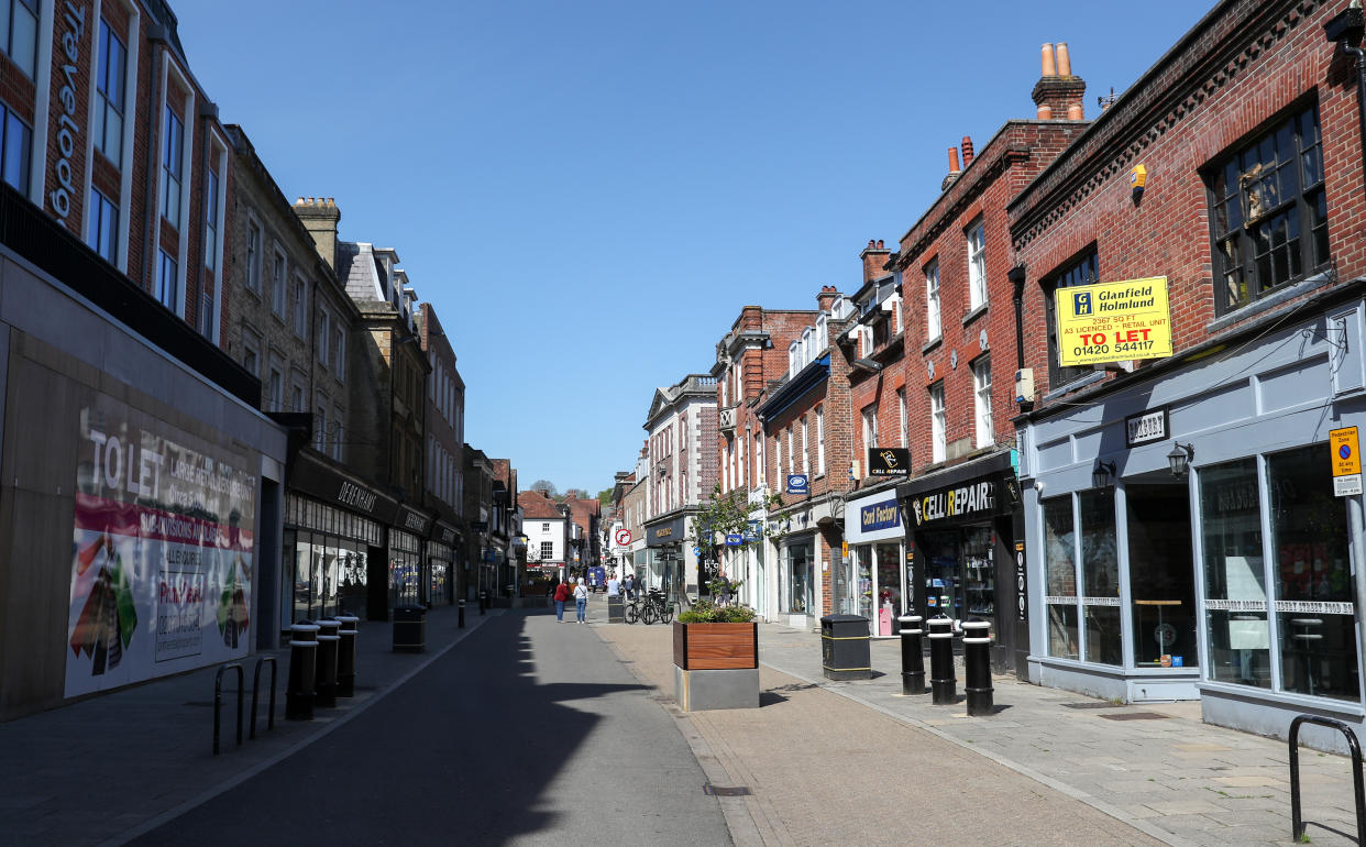 People walk along a near empty High Street in Winchester, as the UK continues in lockdown to help curb the spread of the coronavirus. Photo: Andrew Matthews/PA Images via Getty Images