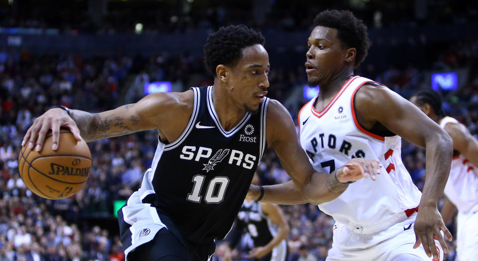 DeMar DeRozan dribbles the ball as Kyle Lowry defends. (Photo by Vaughn Ridley/Getty Images)