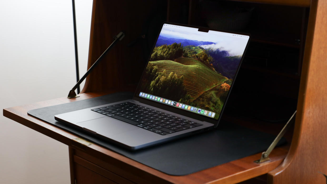  Apple MacBook Pro sitting on a desk. 