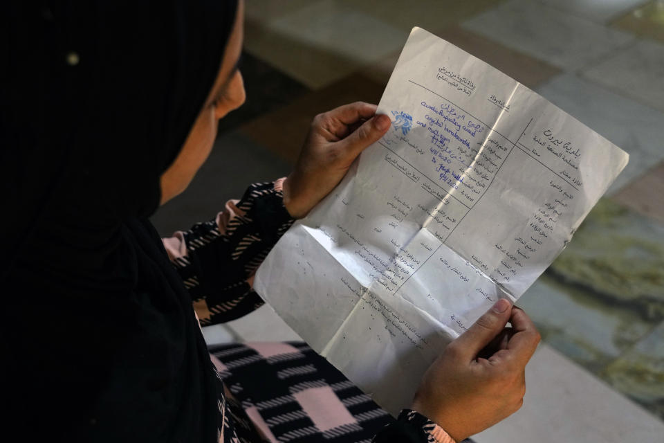 Syrian refugee Sarah Jassem Mohammed holds the death certificate of her five-month-old son Qusai, who was killed in the 2020 Beirut port explosion in Markabta, near Tripoli, Lebanon, Wednesday, July 26, 2023. Three years after the blast, some victims have not been listed, including Qusai. Naming Qusai would make him the blast's youngest victim and allow his family, refugees from Syria, to seek compensation. (AP Photo/Bilal Hussein)
