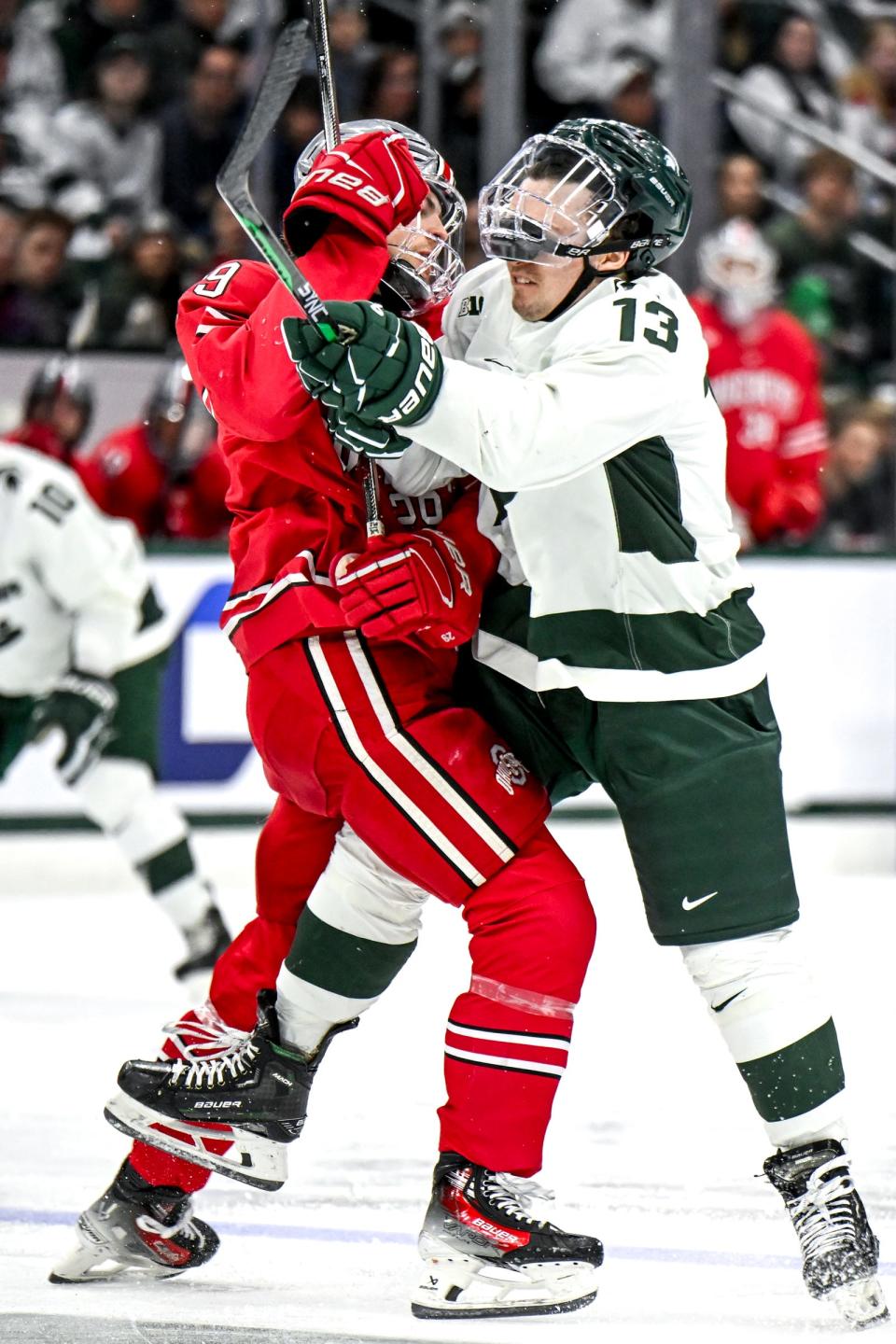 Michigan State's Tiernan Shoudy, right, hits Ohio State's Riley Hughes in the second period of the Big Ten tournament game on Saturday, March 16, 2024, at Munn Arena in East Lansing.