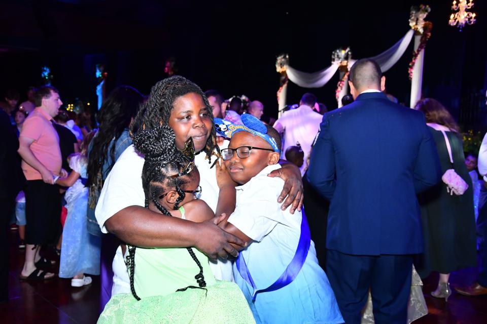 A Wish family shares a special moment at the Once Upon a Wish Party.