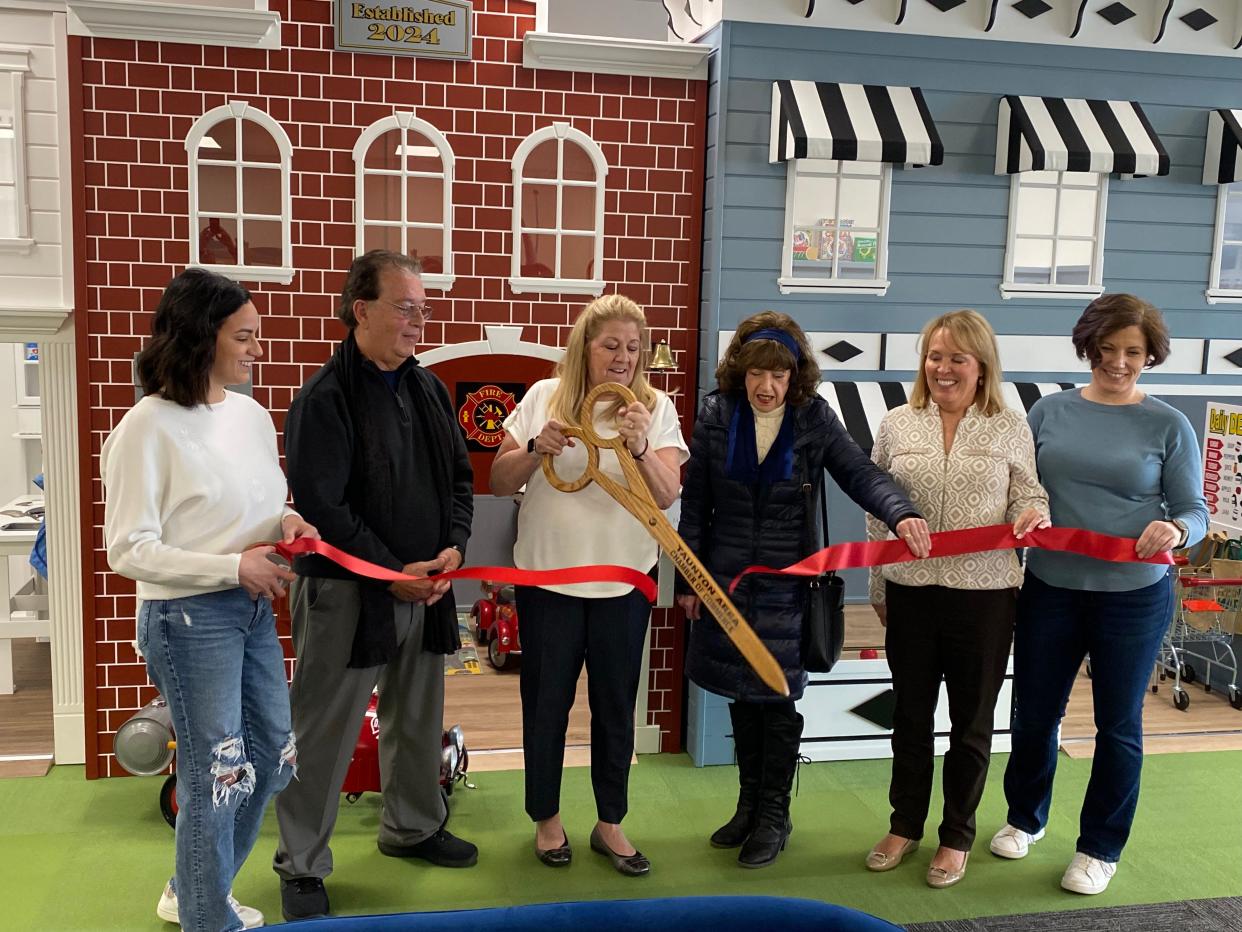 From left, My Village Playhouse co-owner Melissa Pina; Louis Loura, representing State Sen. Marc Pacheco; co-owner Lynne Pina; Raynham Selectman Patricia Riley; Taunton Chamber of Commerce President Kris Silva; and co-owner Melynda Gates at the ribbon cutting on Monday, March 25, 2024.