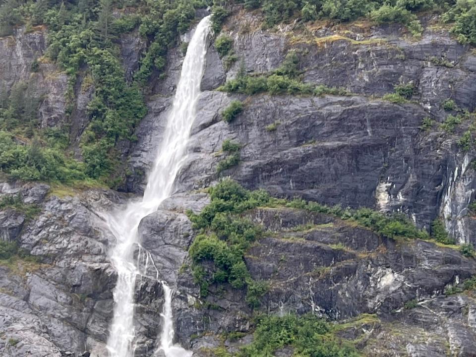 waterfall over stone and greenery