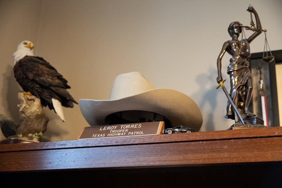 At his home office in Robstown, Le Roy Torres displays a bald eagle statue, his Texas Department of Public Safety trooper hat and a statue of Lady Justice that he purchased at the U.S. Supreme Court gift shop.