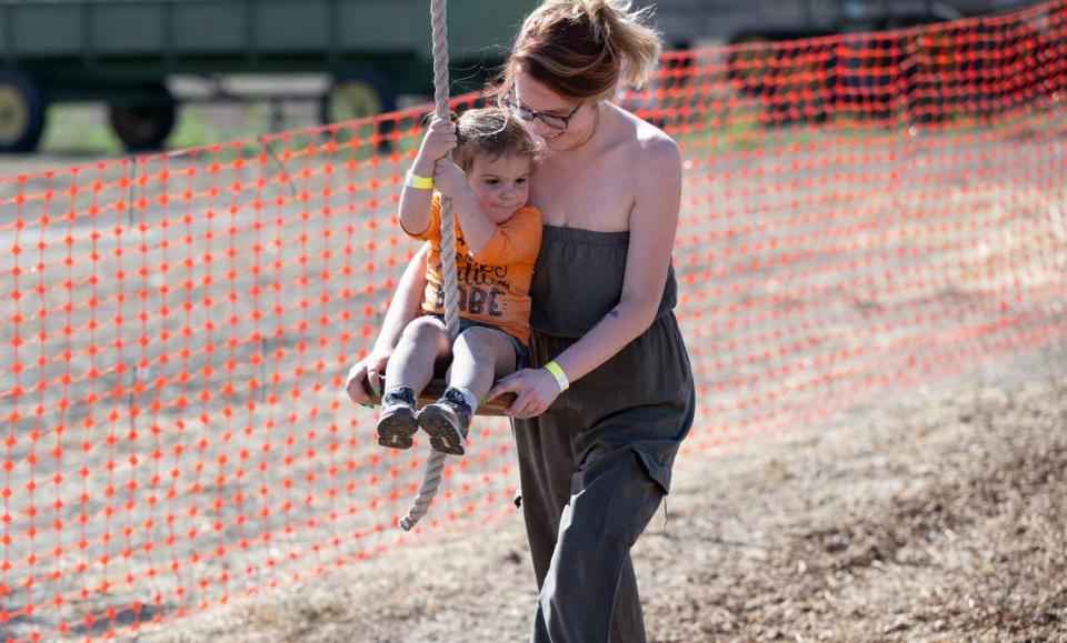 Anika Anaya guides her daughter Josie, 2, on the zip line at Dutch Hollow Farms in Modesto, Calif., Thursday, Oct. 5, 2023.