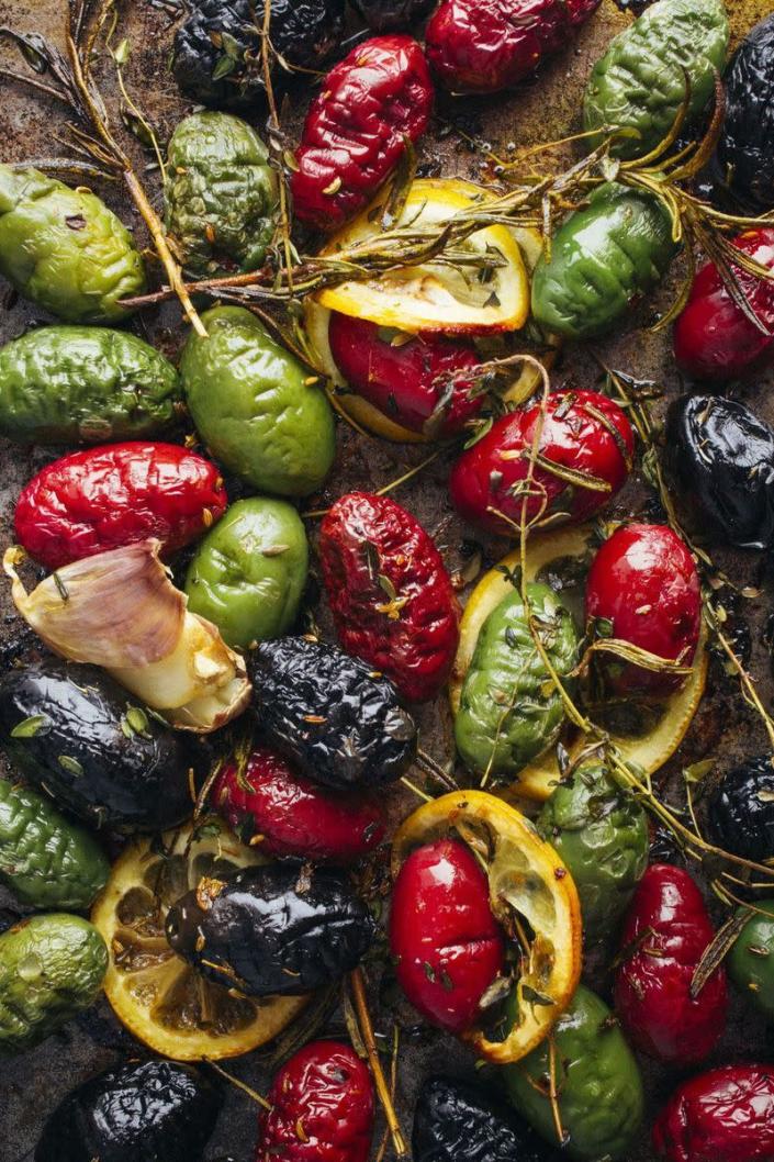 <p>You can't go wrong with roasted vegetables, especially ones that are seasoned with rosemary, thyme, and red pepper. </p><p><em><strong>Get the recipe from <a href="https://www.goodhousekeeping.com/food-recipes/easy/a46631/roasted-olives-with-lemon-garlic-and-herbs-recipe/" rel="nofollow noopener" target="_blank" data-ylk="slk:Good Housekeeping" class="link rapid-noclick-resp">Good Housekeeping</a>.</strong></em></p>