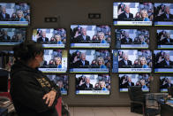 An Israeli electronics store employee looks at a wall of televisions broadcasting live the 59th U.S. Presidential Inauguration ceremony, in Ashkelon, Israel, Wednesday, Jan. 20, 2021. Biden became the 46th president of the United States on Wednesday. (AP Photo/Tsafrir Abayov)