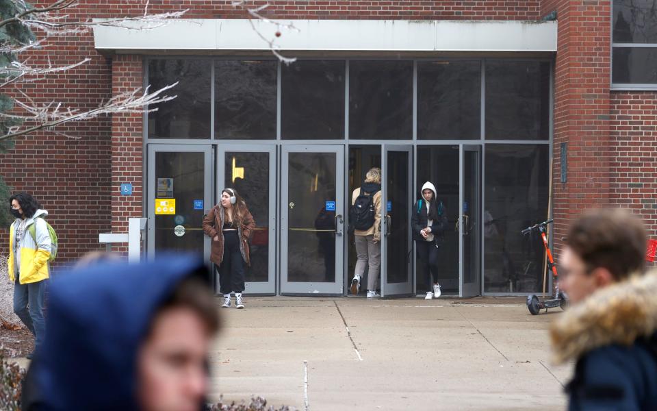 University of Michigan students walk in and out of Mason Hall on the campus in Ann Arbor on Thursday, Feb. 23, 2023.