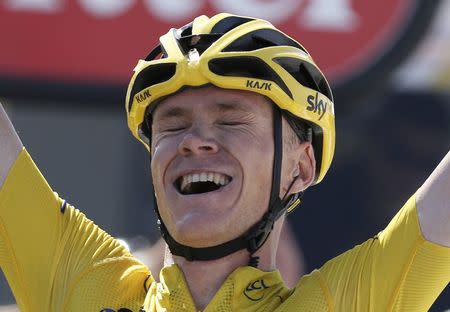 Team Sky rider Chris Froome of Britain, race leader's yellow jersey, celebrates as he crosses the finish line to win the 167-km (103.7 miles) 10th stage of the 102nd Tour de France cycling race from Tarbes to La Pierre-Saint -Martin, France, July 14, 2015. REUTERS/Stefano Rellandini