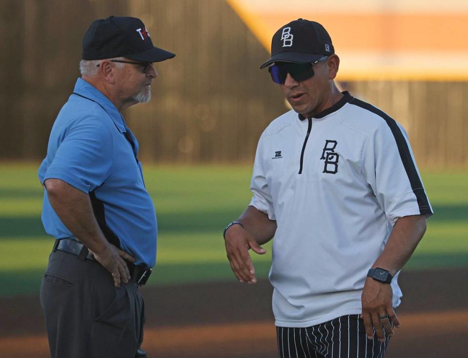 Benbrook head coach Justin Chavez talks with the third base umpire during a UIL District 4A Region 2 Quarterfinals at Coppell Baseball Complex in Coppell, Texas, Friday, May 17, 2024.