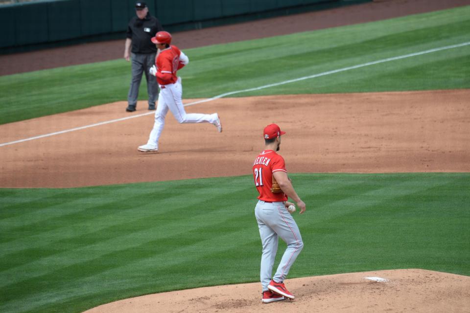 Mar 15, 2021; Tempe, Arizona, USA; Cincinnati Reds relief pitcher Michael Lorenzen (21) reacts after surrendering a home run to Los Angeles Angels designated hitter Shohei Ohtani (17) during the first inning at Tempe Diablo Stadium. Mandatory Credit: Joe Camporeale-USA TODAY Sports