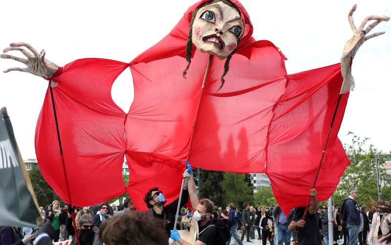 FILE PHOTO: Demonstrators carry an effigy during a protest outside Greek parliament by actors and workers in the music industry in demand of state aid to mitigate financial losses due to the coronavirus disease (COVID-19) outbreak in Athens