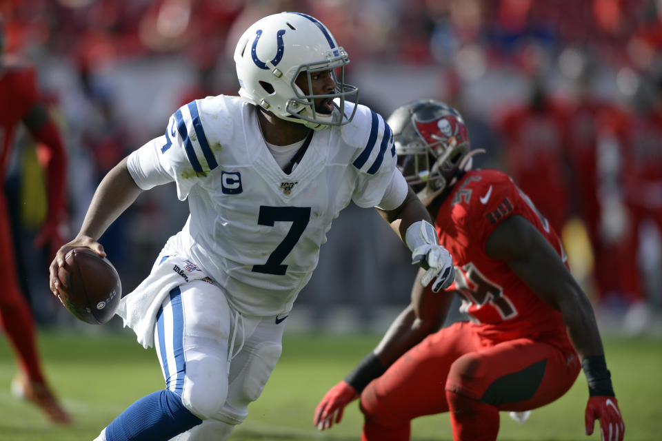 Indianapolis Colts quarterback Jacoby Brissett (7) runs away from Tampa Bay Buccaneers outside linebacker Lavonte David (54) during the second half of an NFL football game Sunday, Dec. 8, 2019, in Tampa, Fla. (AP Photo/Jason Behnken)