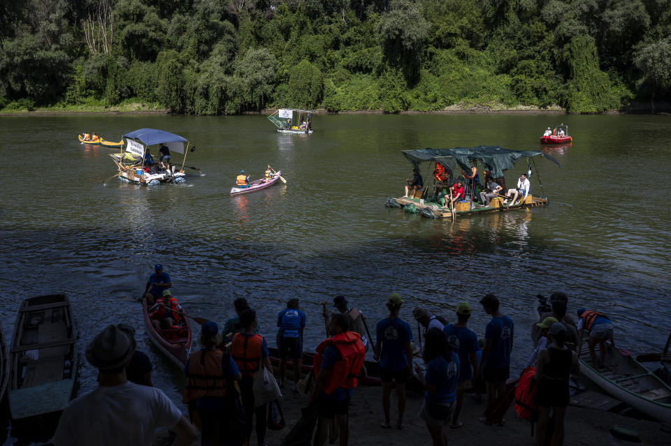 Volunteers set on the Tisza River on their canoes and boats as they participate in Plastic Cup event near Tiszaroff, where they scour Hungary's second-largest river for trash on Tuesday, Aug. 1, 2023. Since its start in 2013, participants in the annual competition — which offers a prize for those who collect the most trash each year — have gathered more than 330 tons (around 727,000 pounds) of waste from the Tisza and other Hungarian waters. (AP Photo/Denes Erdos)
