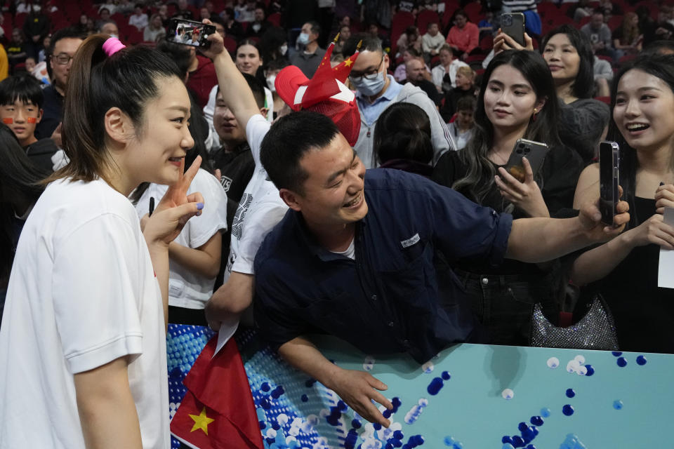 China's Li Meng poses for a selfie for fans following during their game at the women's Basketball World Cup against Puerto Rico in Sydney, Australia, Monday, Sept. 26, 2022. (AP Photo/Mark Baker)