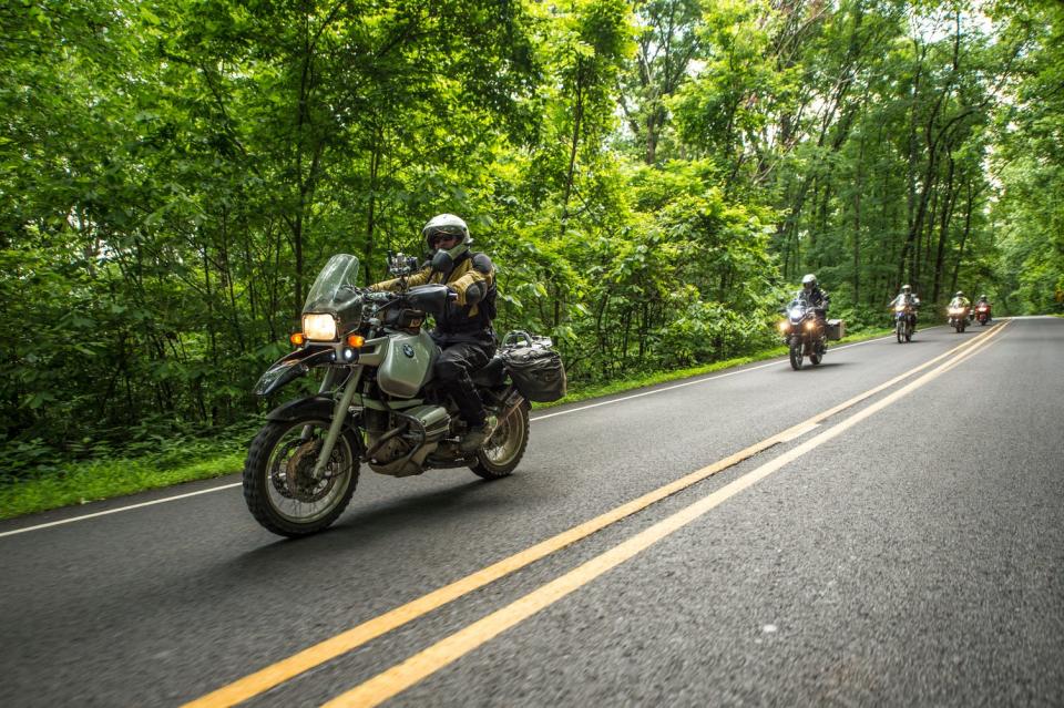 Twisting through the Ozark National Forest on Arkansas State Highway 23, the Pig Trail Scenic Byway takes riders through curves and climbs and under canopies of trees.