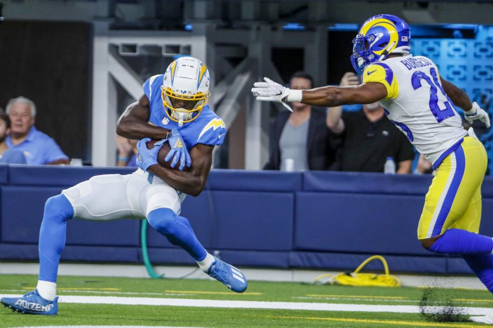 Chargers wide receiver Joe Reed hauls in a touchdown pass in front of Rams safety Terrell Burgess on Aug. 13, 2022.