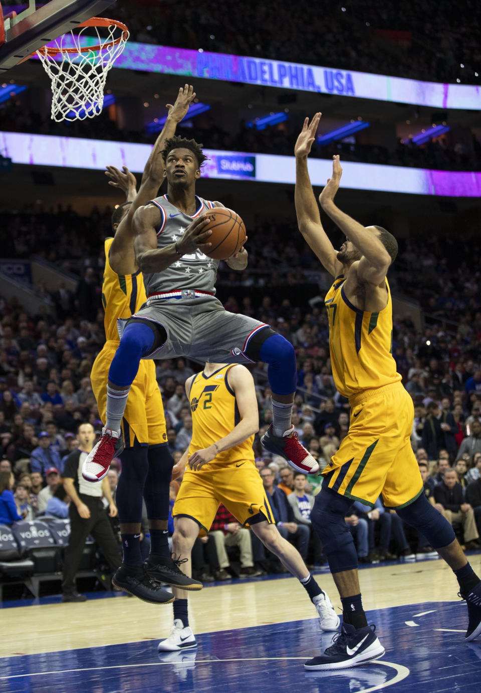 Philadelphia 76ers' Jimmy Butler, center, goes up to shoot against Utah Jazz's Derrick Favors, left, and Rudy Gobert, right, of France, during the first half of an NBA basketball game, Friday, Nov. 16, 2018, in Philadelphia. (AP Photo/Chris Szagola)