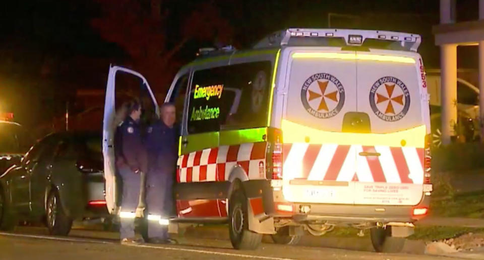 An ambulance outside a home in Sydney's west where a 57-year-old woman was allegedly decapitated in front of her grandson.