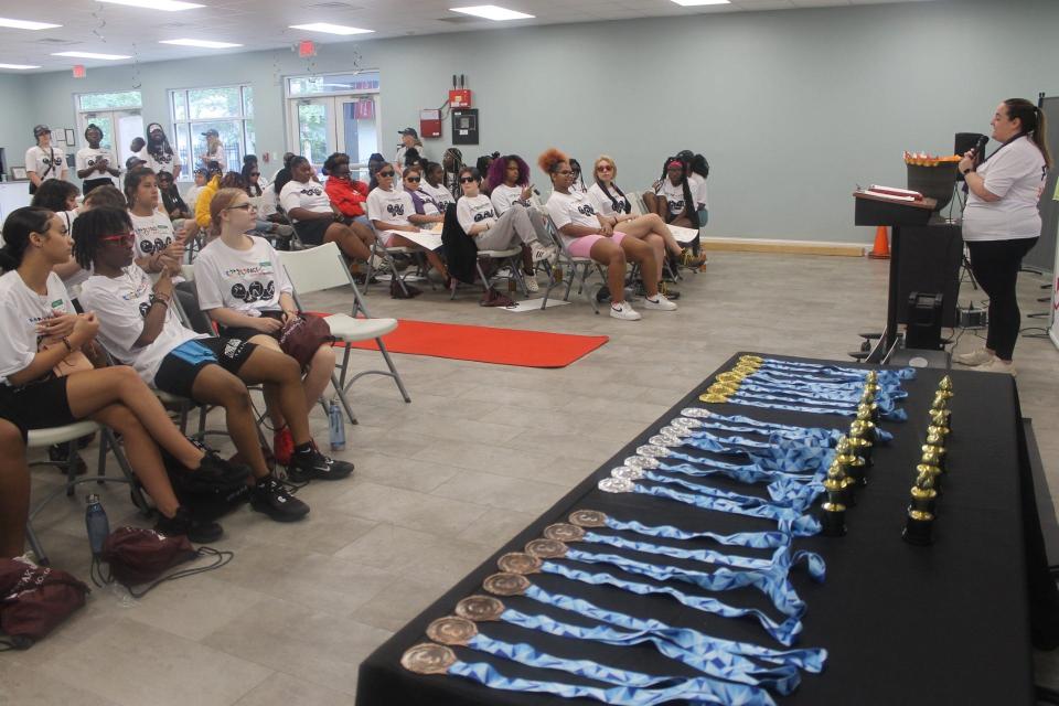 Jessica Bone, program coordinator at Pace Center for Girls Alachua, right, speaks to students participating in the Pace Center for Girls Alachua inaugural Pace Olympics.