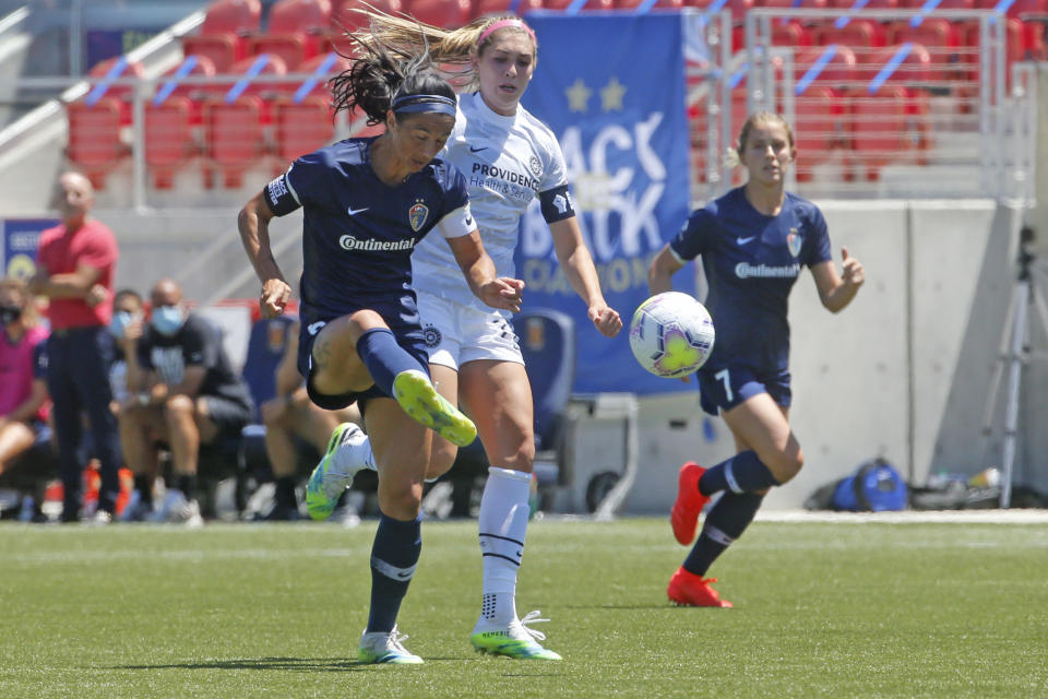 North Carolina Courage defender Abby Erceg, left, kicks the ball as Portland Thorns forward Morgan Weaver, center, looks on during the second half of an NWSL Challenge Cup soccer match at Zions Bank Stadium Saturday, June 27, 2020, in Herriman, Utah. Coach Paul Riley calls Erceg the bedrock of the North Carolina Courage. The New Zealand native is captain of the Courage, the two-time National Women's Soccer League defending champions.(AP Photo/Rick Bowmer)