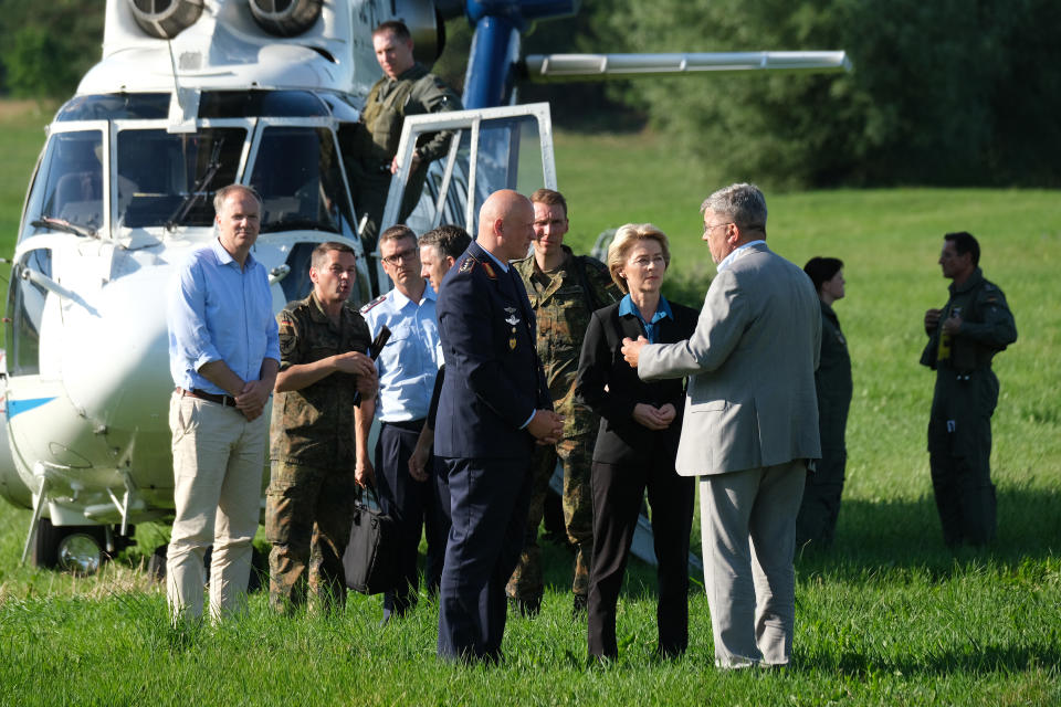 NOSSENTIN, GERMANY - JUNE 24: German Defense Minister Ursula von der Leyen (C) arrives near the crash site of one of two Bundeswehr Eurofighter fighter jets on June 24, 2019 near Nossentin, Germany. Two Eurofighters collided during training earlier today, leaving one pilot dead. (Photo by Sean Gallup/Getty Images)