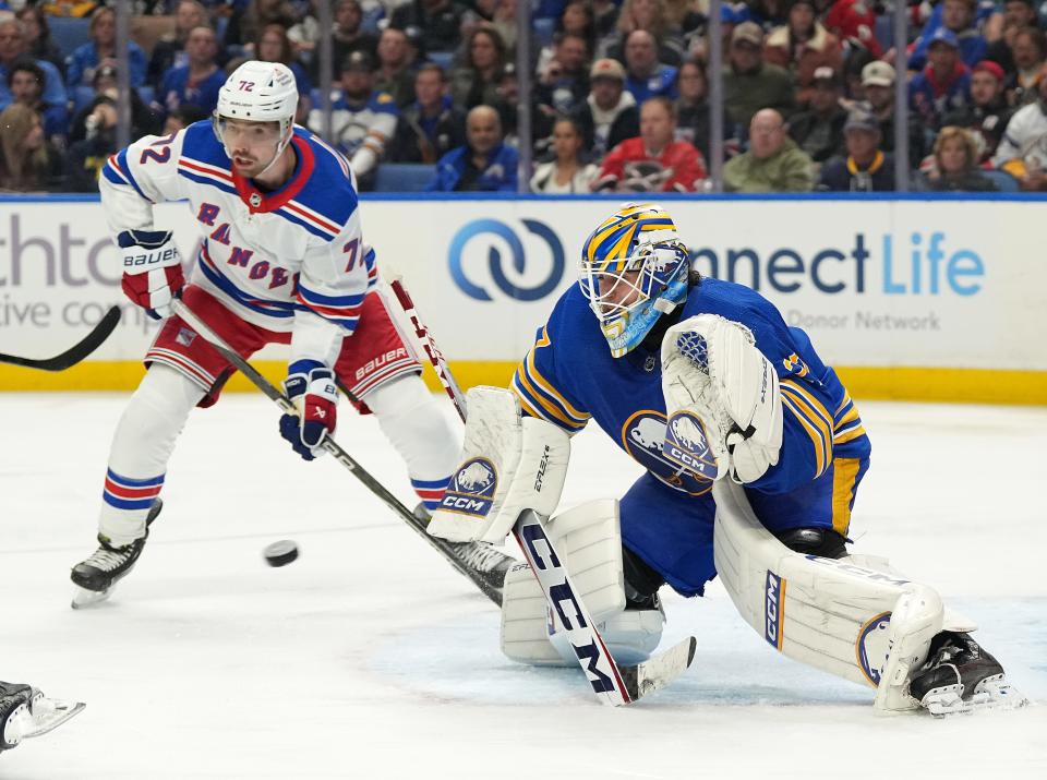 BUFFALO, NY - OCTOBER 12: Devon Levi #27 of the Buffalo Sabres makes the save as Filip Chytil #72 of the New York Rangers looks on during the third period at KeyBank Center on October 12, 2023 in Buffalo, New York.