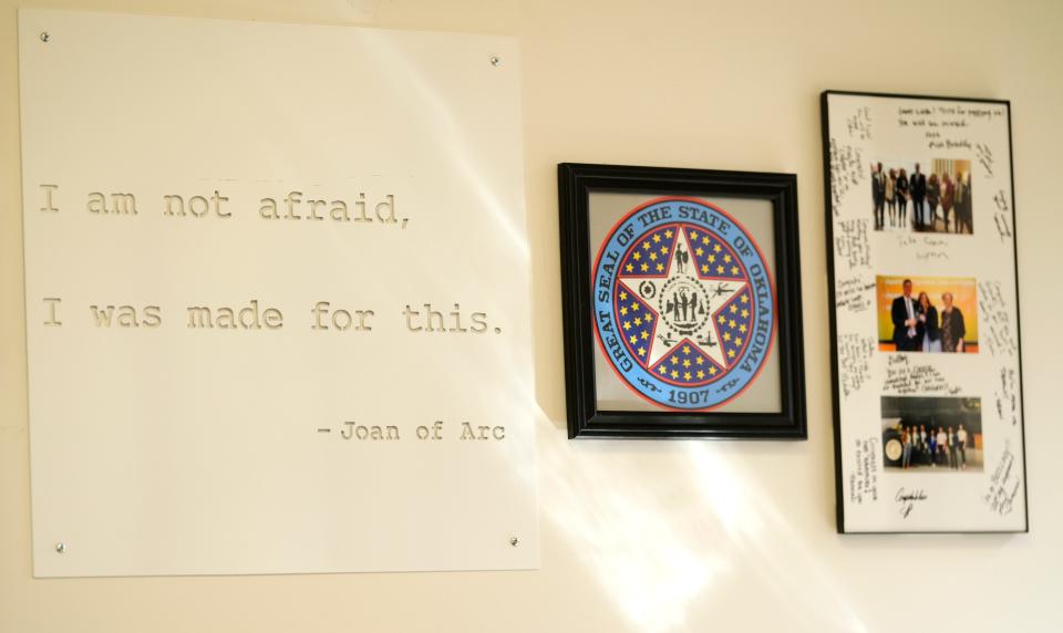 A wall in the office of Shelley Zumwalt, executive director of the Oklahoma Tourism and Recreation Department, bears a quote from Joan of Arc.