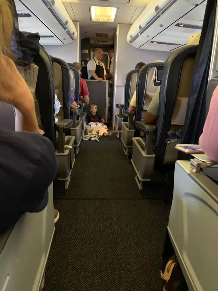 Braysen spent most of the flight on the floor where he could feel the vibrations of the plane and felt comfortable. Source: Lori Gabriel