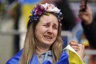 A Ukraine fan in the stands sheds a tear before the World Cup 2022 qualifying play-off soccer match between Wales and Ukraine at Cardiff City Stadium, in Cardiff, Wales, Sunday, June 5, 2022. (Mike Egerton/PA via AP)