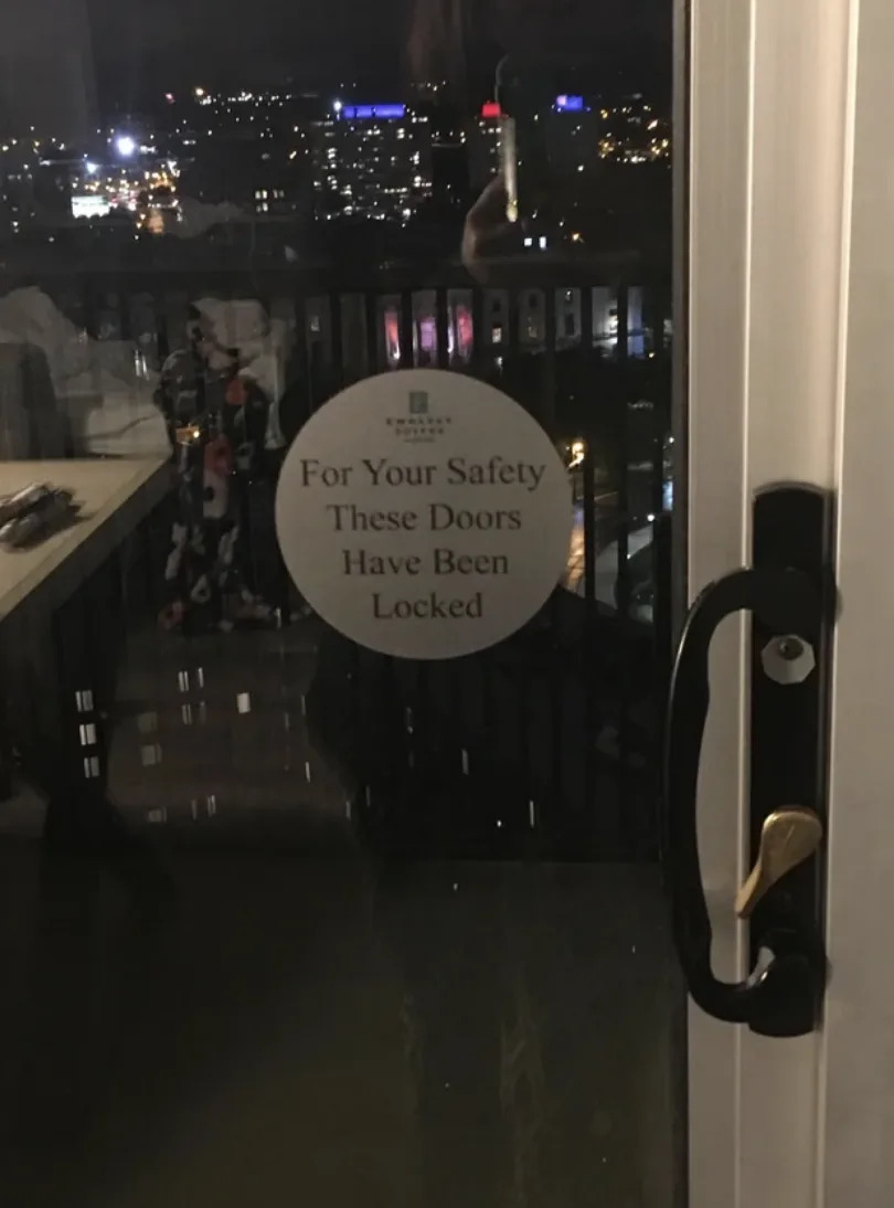 Message on the balcony door reading, "For your safety these doors have been locked"