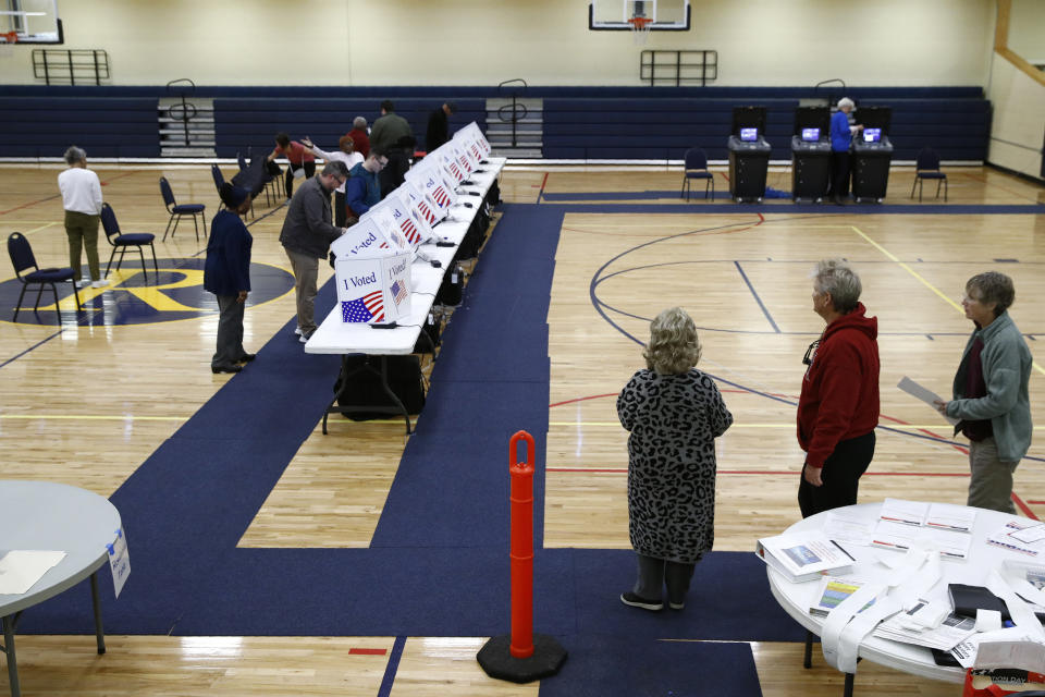 FILE - Voters fill out their ballots at a primary polling place, Feb. 29, 2020, in North Charleston, S.C. Democrats elevated South Carolina to the top of their presidential primary calendar, leapfrogging Iowa and New Hampshire. Republicans, meanwhile, could potentially have two homegrown South Carolina presidential candidates in the race, a prospect that has already caused friction among the state’s GOP circles of supporters. (AP Photo/Patrick Semansky, File)