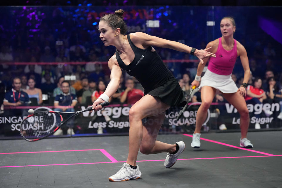 Belgium's Nele Gilis (left) return a shot against her sister Tinne Gilis during the women's final of the Singapore Squash Open. (PHOTO: Vincent Thian/Singapore Squash Open)