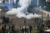 Argentina's fans clash with riot police after Argentina lost to Germany in their 2014 World Cup final soccer match in Brazil, at a public square viewing area in Buenos Aires, July 13, 2014. (REUTERS/Ivan Alvarado)